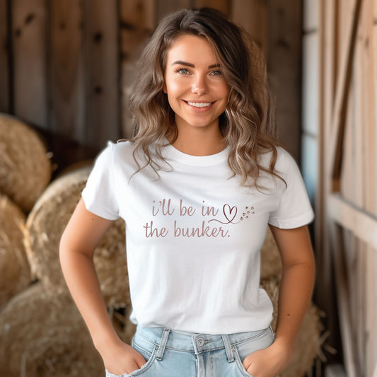 women wearing a white t-shirt saying I'll be in the bunker with a image of a heart, pink imprint